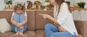 A mother appears to yell while pointing at her daughter sitting on the couch. This could represent an Authoritarian parenting style that a family therapist in Englewood, CO can help you better understand. Learn more about family therapy in Greenwood Village, CO, and family therapy in Englewood, CO today. 