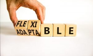 A close up of a hand moving blocks with letters. The fingers flip some, changing the word from adapatable to flexible. Learn how an anxiety therpaist in Englewood, CO can help you become more flexible via anxiety therapy in Greenwood Village, CO. They can offer remote support via online therapy in Colorado and more. 