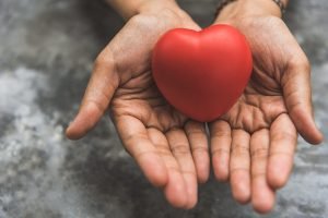 A close up of hands cupping a foam heart. This could represent the love cultivated by working with a couples therapist in Englewood, CO. Search for couples therapy in Littleton, CO, and how relationship counseling in Englewood, CO can help. 
