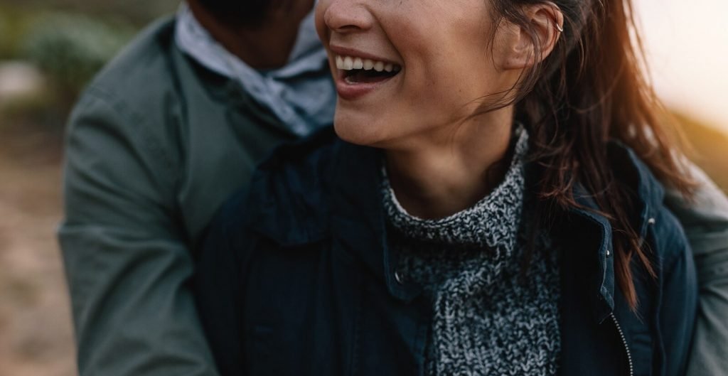 A close up of a couple smiling while embracing in the evening sunlight. Learn how a couples therapist in Englewood, CO can offer support via relationship counseling in Englewood, CO, today. Search for couples therapy in Greenwood Village, CO for more support!