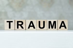 A close up of wooden blocks with letters that spell trauma. Learn how neurofeedback therapy in Greenwood Village, CO can offer support with trauma therapy in Greenwood Village, CO. Contact a therapist or search for "neurofeedback therapy denver" for support. 