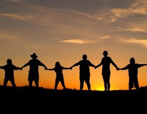 A silhouette of a family holding hands while standing in a line. Learn how a family therapist Greenwood Village, CO can offer support with family therapy in Englewood, CO. Search for a family therapist in Englewood, CO to learn more about how family counseling can help.