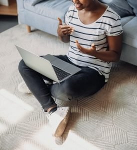 A close up of a woman smiling and gesturing while on a laptop. This could represent the remote support that online therapy in Colorado can offer with an autism therapist in Greenwood Village, CO. Search for an ASD therapist in Englewood, CO to learn more support today. 