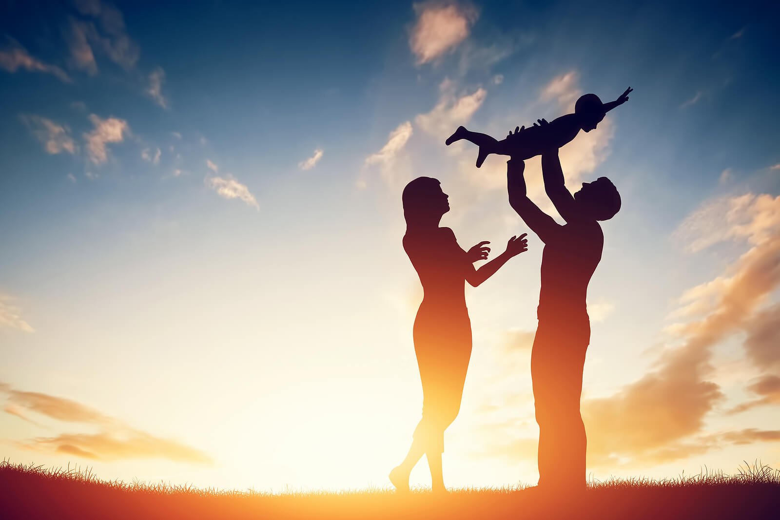 A silhouette of two parents joyfully lifting their young child into the air against a warm sunset sky, capturing the deep love and playful connection that ADHD parents bring to their families. With the right support from an ADHD therapist for adults in Englewood, CO or an ADHD therapist for adults in Colorado, parents can move from shame and overwhelm toward confidence and intentional connection. This kind of hopeful, thriving family life is exactly what ADHD therapy works toward. 